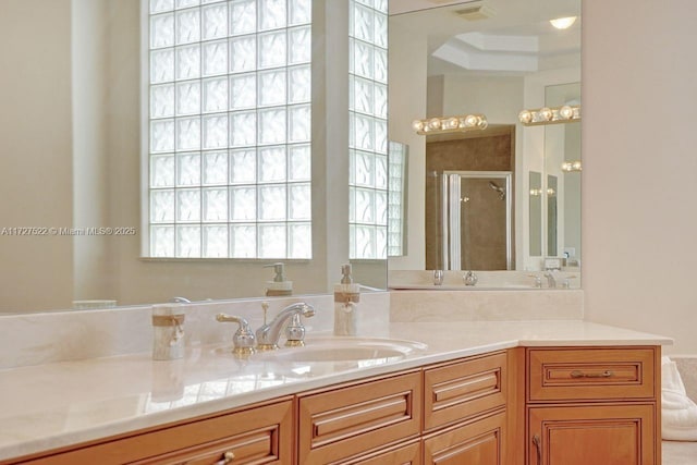 bathroom with vanity and a shower with door