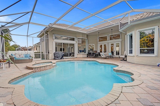 view of pool featuring ceiling fan, an in ground hot tub, a lanai, french doors, and a patio