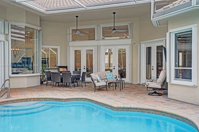 view of pool with ceiling fan, french doors, and a patio