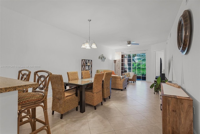 dining room featuring ceiling fan with notable chandelier and light tile patterned floors