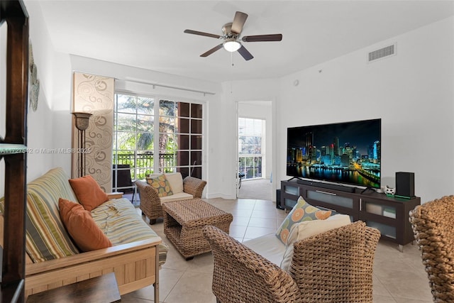 tiled living room with ceiling fan