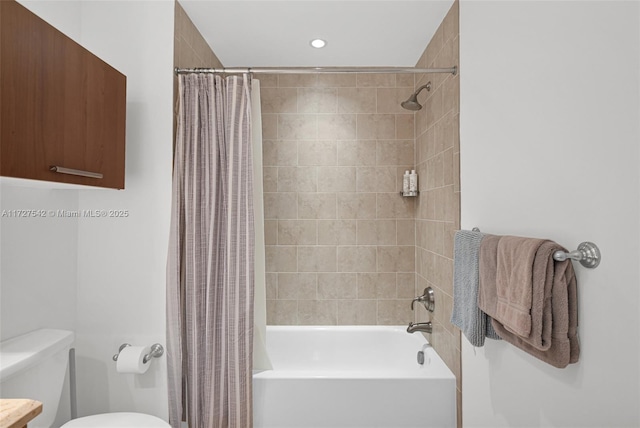 bathroom featuring toilet and shower / tub combo with curtain