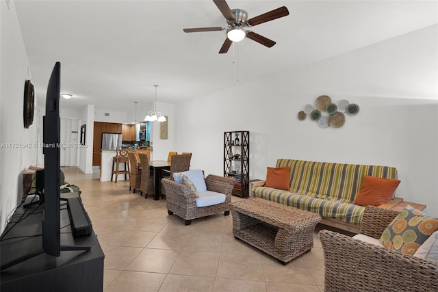 tiled living room featuring ceiling fan with notable chandelier