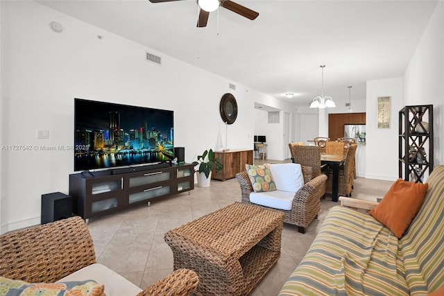 living room featuring light tile patterned floors and ceiling fan with notable chandelier