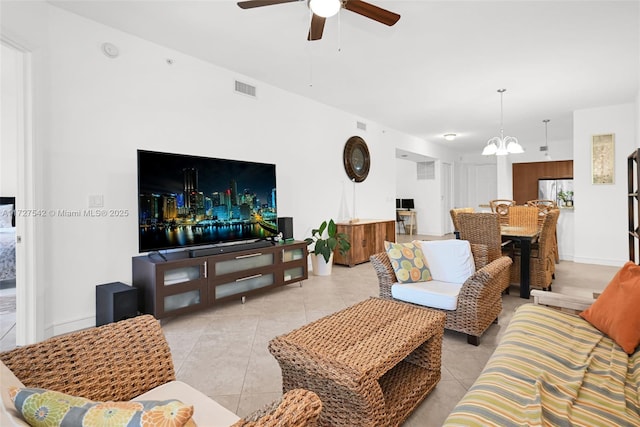 living room with light tile patterned floors and ceiling fan with notable chandelier