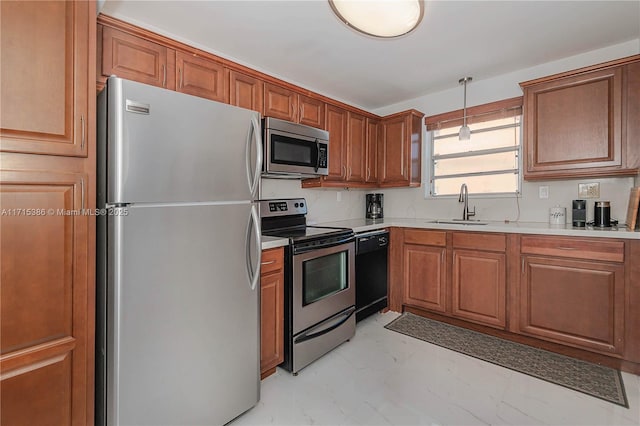 kitchen featuring sink, hanging light fixtures, and appliances with stainless steel finishes