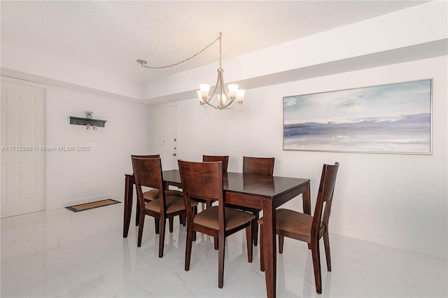 dining room featuring a textured ceiling and an inviting chandelier