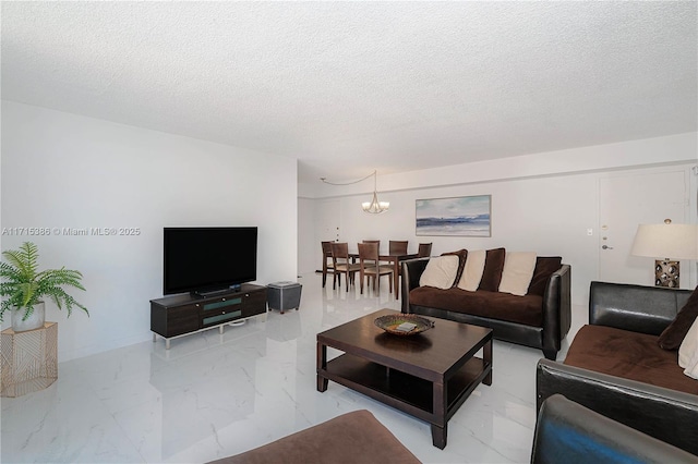 living room featuring a textured ceiling and a notable chandelier