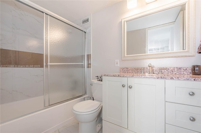 full bathroom with shower / bath combination with glass door, vanity, and toilet