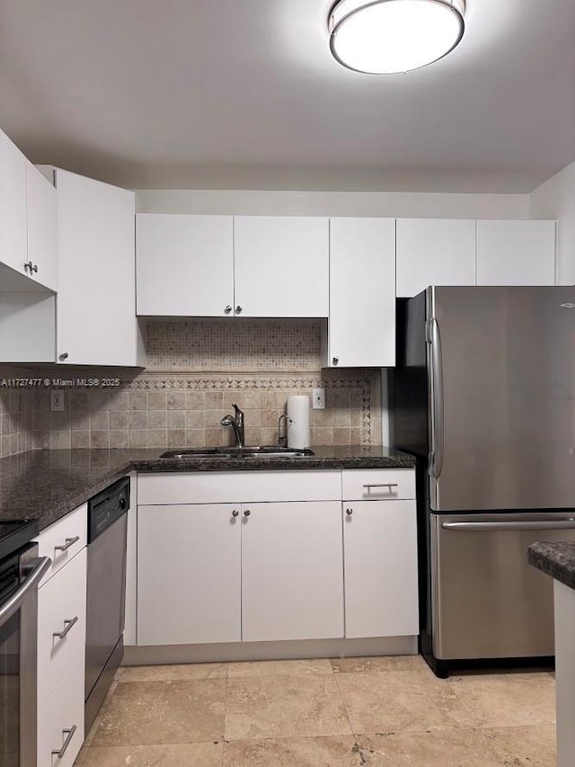 1401 NE Miami Gardens Dr Unit 892, Miami, FL 33179 - kitchen with sink, dark stone countertops, stainless steel appliances, and white cabinetry