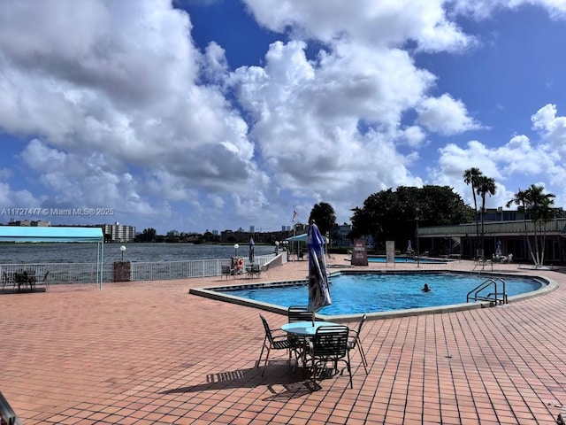 1401 NE Miami Gardens Dr Unit 892, Miami, FL 33179 - view of swimming pool featuring a patio area and a water view