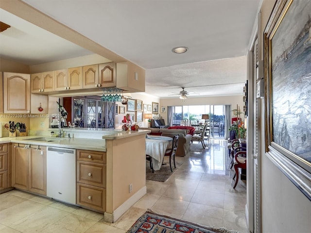 kitchen with ceiling fan, sink, white dishwasher, light tile patterned flooring, and light brown cabinetry