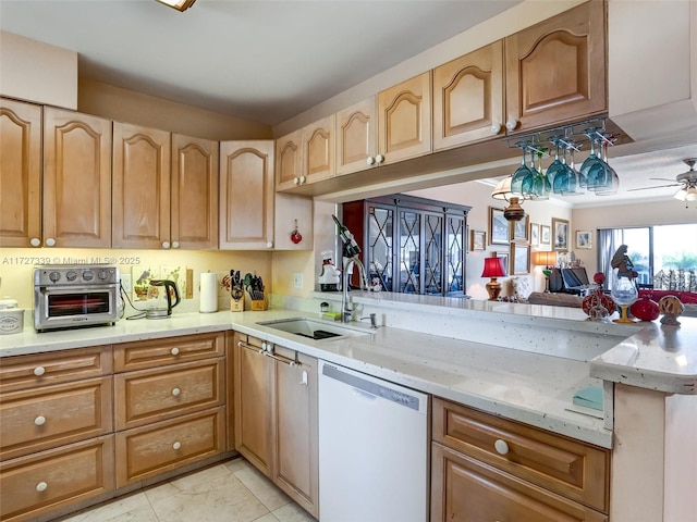 kitchen with ceiling fan, kitchen peninsula, sink, white dishwasher, and light stone counters