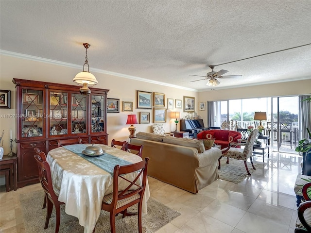 dining room with a textured ceiling, ceiling fan, and crown molding