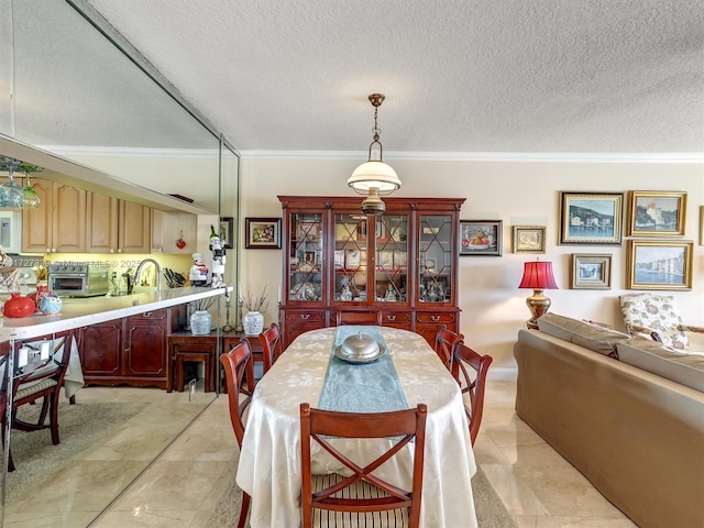 dining area with a textured ceiling, light tile patterned floors, and ornamental molding