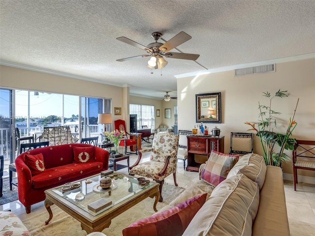 living room with a textured ceiling, ceiling fan, and crown molding