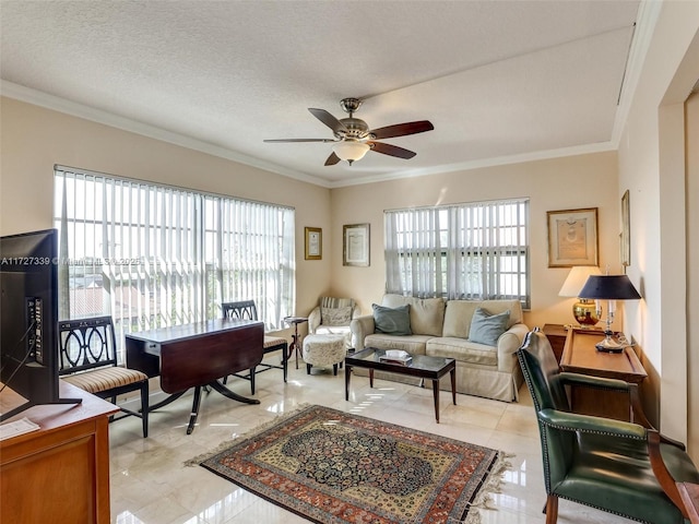 living room with ceiling fan, ornamental molding, and a textured ceiling