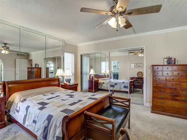 bedroom featuring ceiling fan, a textured ceiling, crown molding, and light carpet