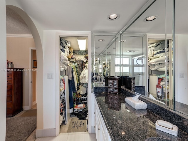 bathroom featuring ornamental molding, tile patterned flooring, and vanity