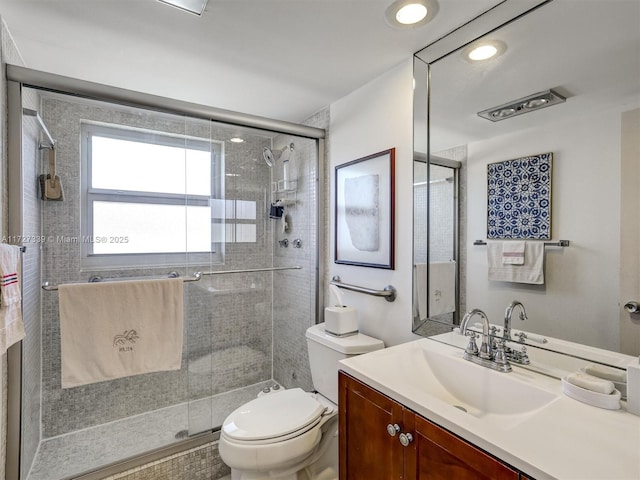 bathroom featuring toilet, vanity, and an enclosed shower