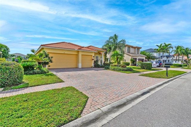 mediterranean / spanish-style home featuring a garage and a front lawn