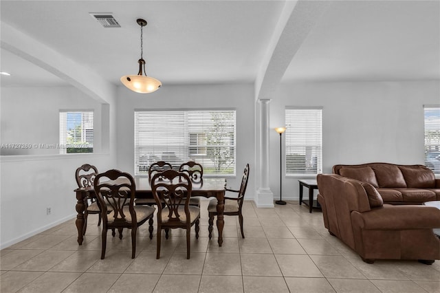 tiled dining area featuring a wealth of natural light and ornate columns