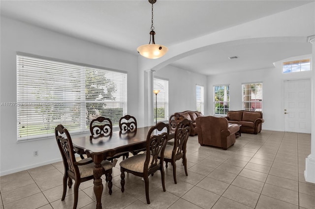 tiled dining space with a wealth of natural light and ornate columns