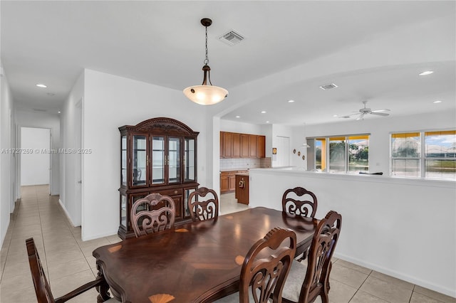 dining space featuring ceiling fan and light tile patterned floors