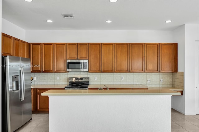 kitchen featuring appliances with stainless steel finishes, a center island, and light tile patterned flooring