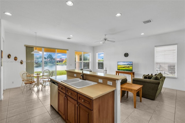 kitchen featuring decorative light fixtures, ceiling fan, dishwasher, sink, and light tile patterned floors