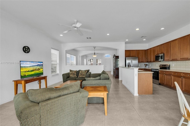 tiled living room featuring ceiling fan