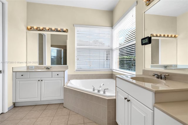 bathroom featuring plus walk in shower, tile patterned flooring, and vanity