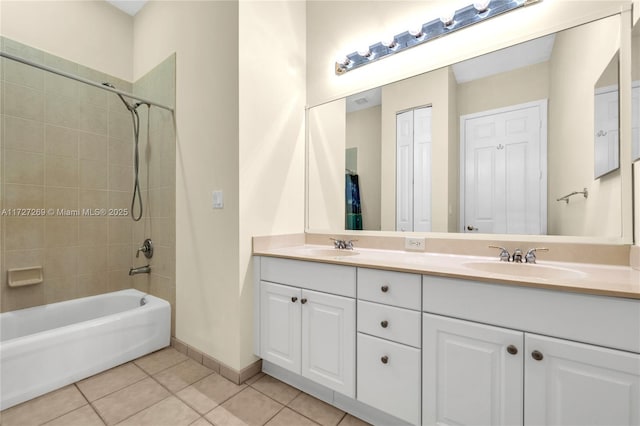 bathroom featuring vanity, tile patterned flooring, and tiled shower / bath combo