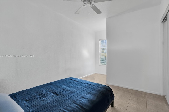 bedroom featuring ceiling fan and light tile patterned floors