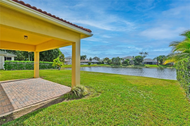 view of yard with a patio area and a water view