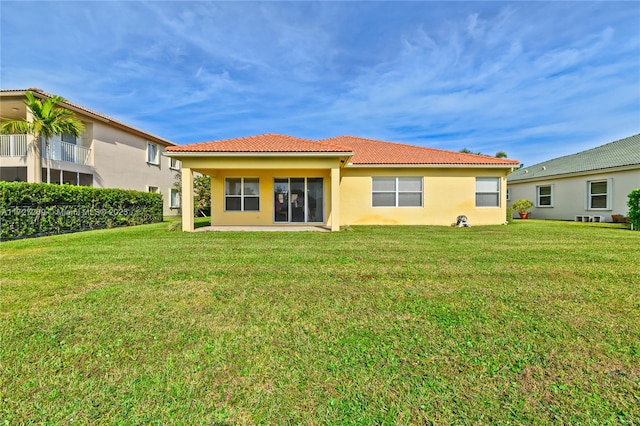 rear view of property with a yard