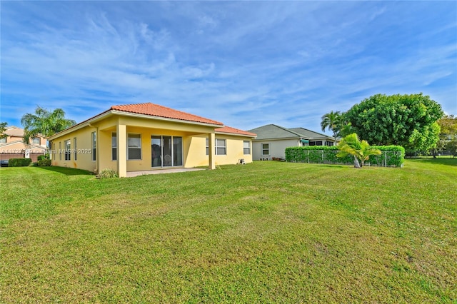 rear view of property with a lawn