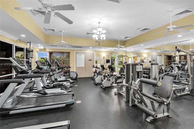 gym featuring ornamental molding, a healthy amount of sunlight, and ceiling fan with notable chandelier