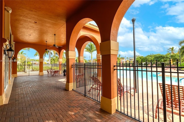 view of patio / terrace featuring ceiling fan and a community pool