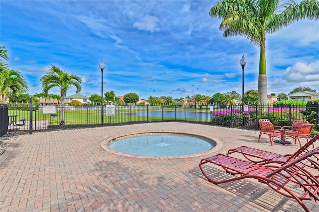 view of swimming pool featuring an in ground hot tub and a patio