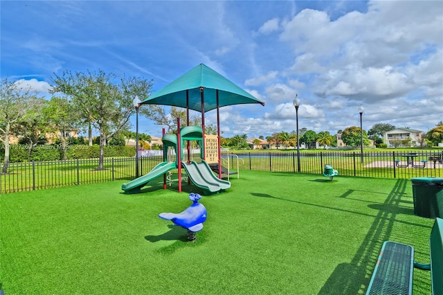 view of playground with a lawn