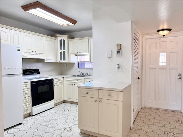 kitchen with range with electric cooktop, sink, and white refrigerator