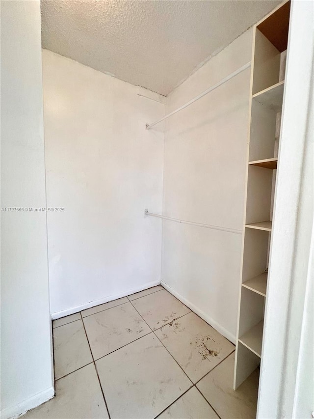 spacious closet with tile patterned floors