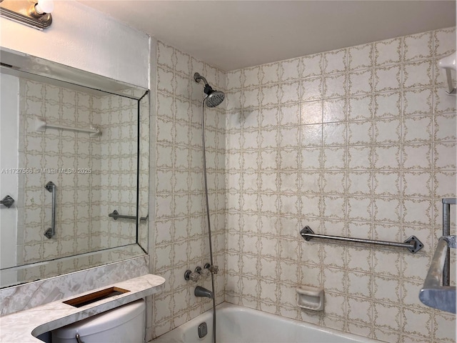 bathroom featuring toilet and tiled shower / bath