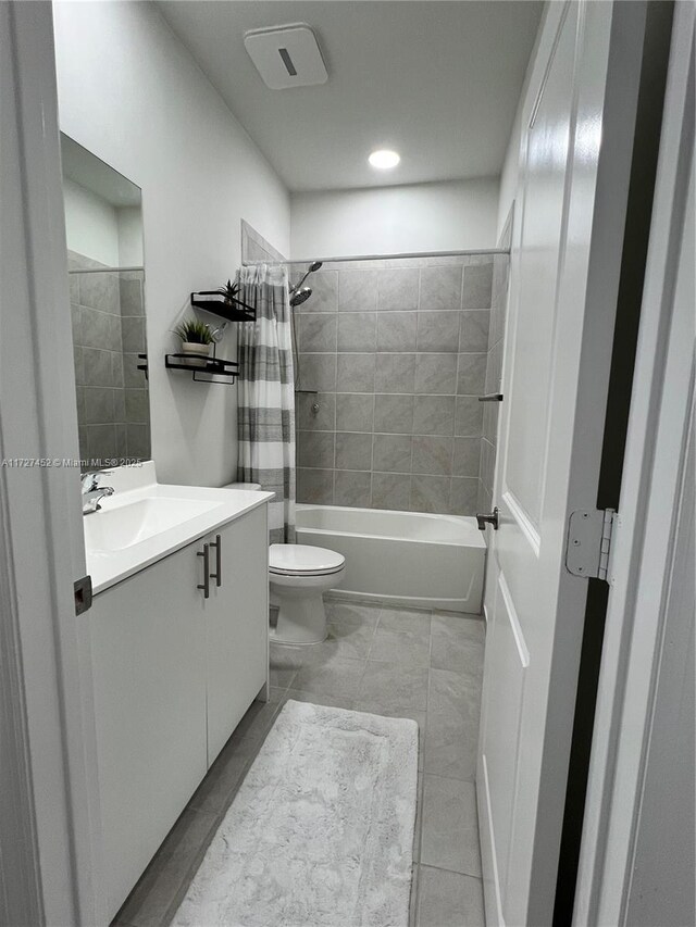 full bathroom featuring toilet, vanity, and shower / bath combination with curtain