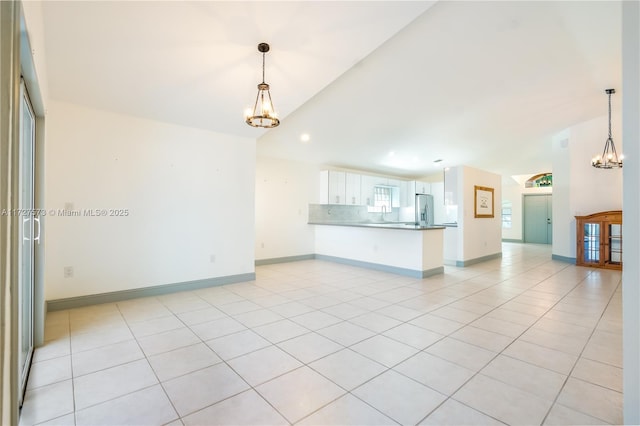 unfurnished living room featuring lofted ceiling, light tile patterned floors, a notable chandelier, and sink