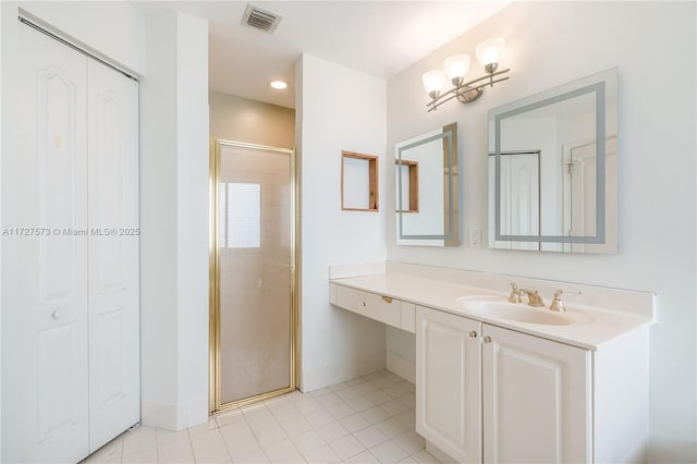 bathroom featuring walk in shower, vanity, and tile patterned flooring