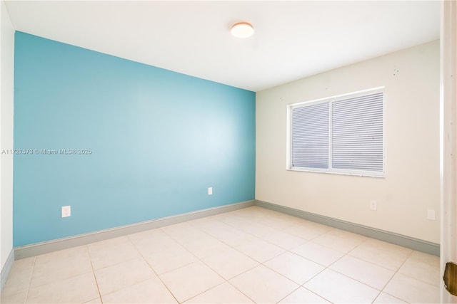 unfurnished room featuring light tile patterned floors