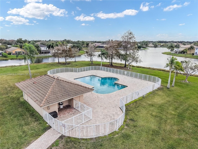 view of pool with a patio area, a lawn, and a water view