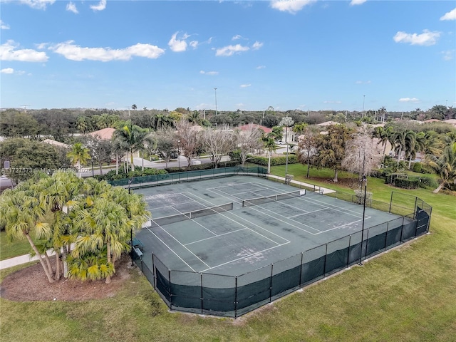 view of sport court with a lawn